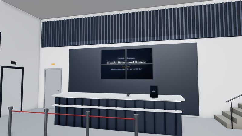 Zona de recepción de un edificio de oficinas con videowall y señalización